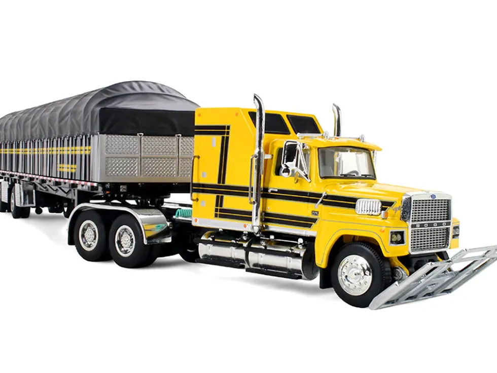 Ford LTL 9000 with 60" Aerodyne Sleeper and 53' Wilson Roadbrute Flatbed Trailer with Covered Wagon Yellow with Black Stripes 1/64 Diecast Model by DCP/First Gear