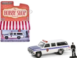 1985 GMC Suburban 2500 "New York City Transit Police Department" White with Blue Stripes and Police Officer Figure "The Hobby Shop" Series 16 1/64 Diecast Model Car by Greenlight
