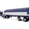 Peterbilt 352 COE 110" Sleeper and 53’ Wilson Roadbrute Flatbed Trailer with Covered Wagon White with Blue Stripes 1/64 Diecast Model by DCP/First Gear