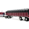 Peterbilt 389 with 63" Flat Top Sleeper and 53’ Wilson Roadbrute Flatbed Trailer with Covered Wagon Maroon with White Stripes 1/64 Diecast Model by DCP/First Gear